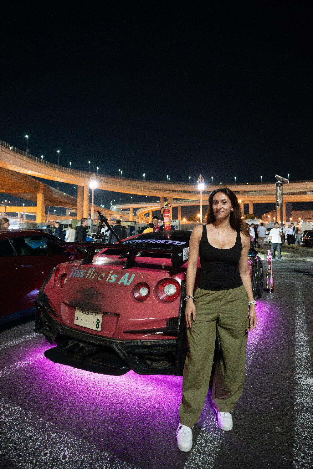 Client posing with a tuned pink GT-R at Daikoku PA