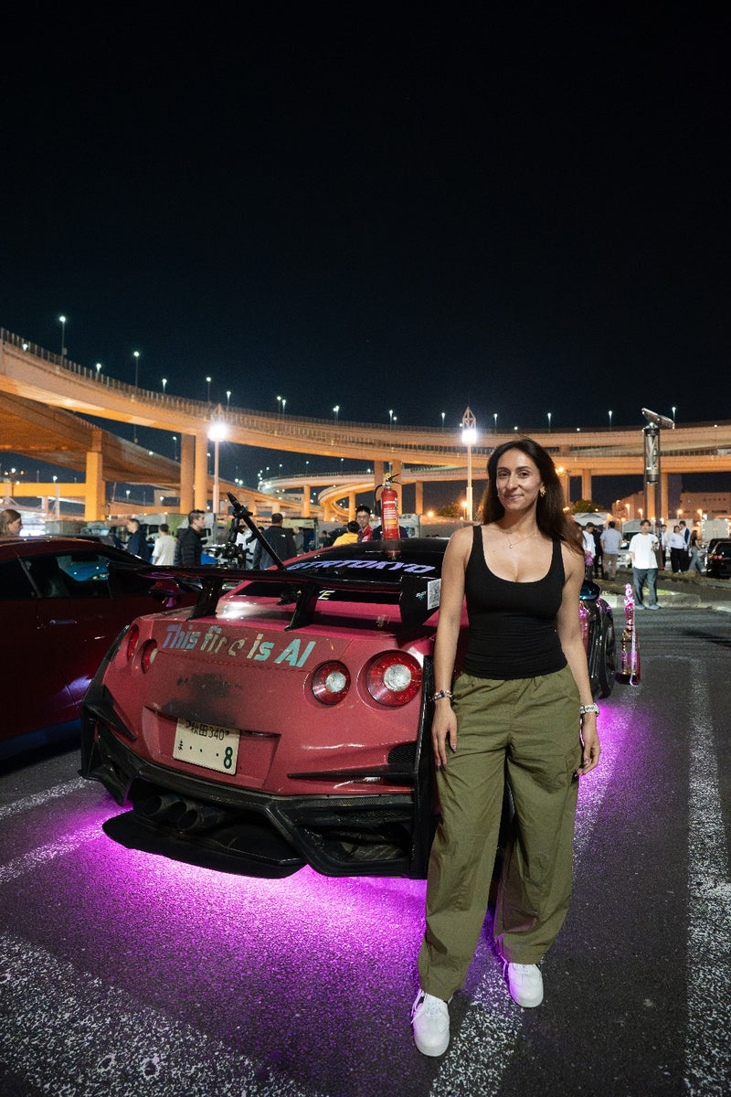 Client posing with a tuned pink GT-R at Daikoku PA
