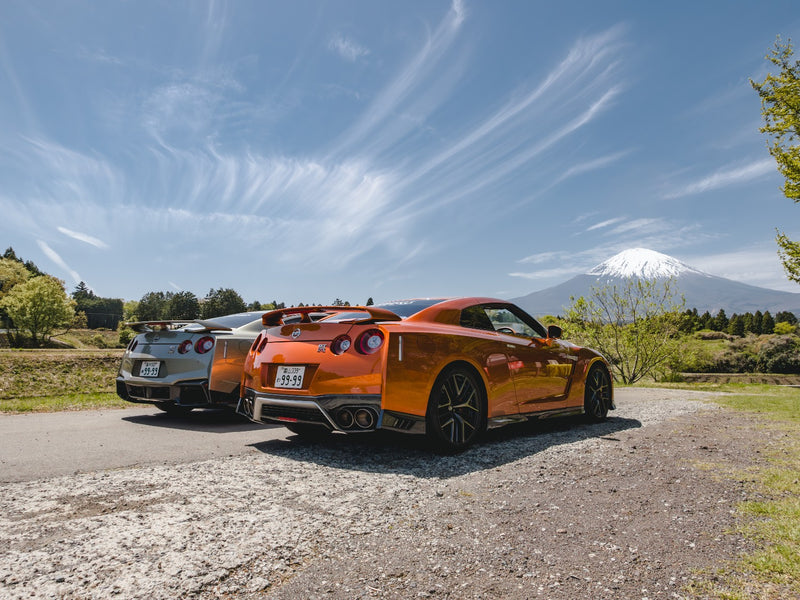 Two Nissan GT-R R35s parked with Mount Fuji in the background