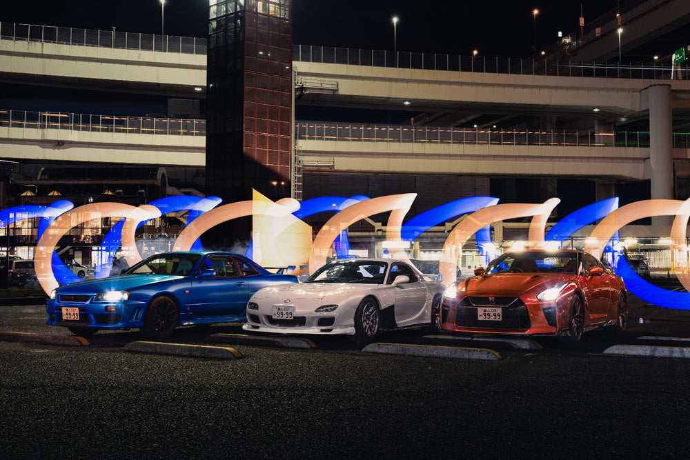 Skyline R34, RX-7 and GT-R with light painting at Daikoku PA at night